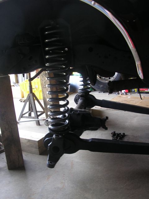 1996 Ford Bronco - The vehicle's suspension system is disassembled, with springs and axles visible.