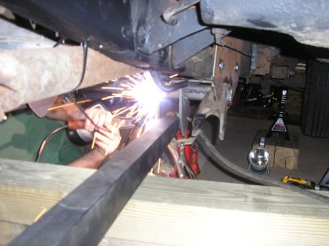 1996 Ford Bronco - A mechanic welds a part of the vehicle's frame, with the Supermotors.net logo visible in the lower right corner.