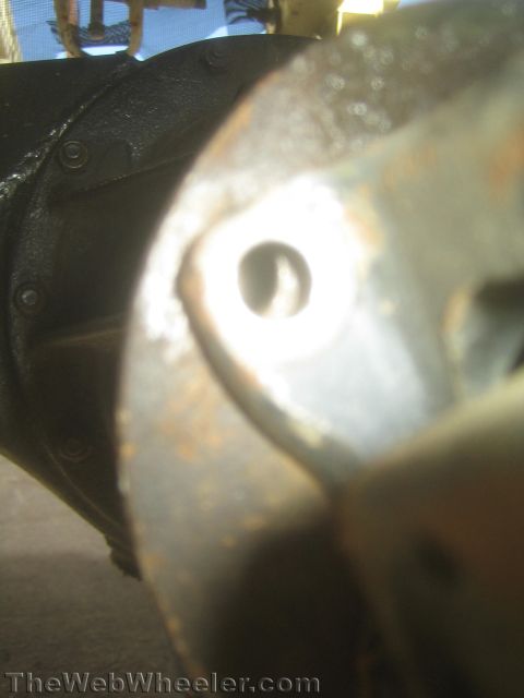 1987 Suzuki Samurai - Close-up view of a vehicle's differential housing, showing bolts and some rust.