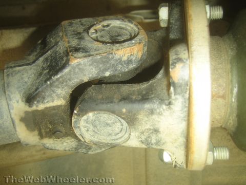 1987 Suzuki Samurai - Close-up view of a vehicle's driveshaft U-joint assembly.