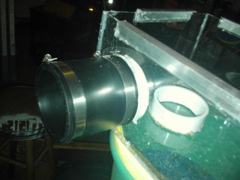 1989 Ford Bronco - Close-up view of a custom exhaust pipe modification, metal banding and white tape securing the connection.