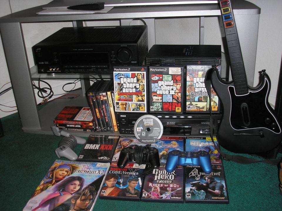 PlayStation 2 console, controllers, games like Grand Theft Auto, and a Guitar Hero controller