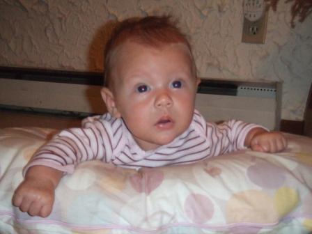 1996 Ford Bronco - A baby wearing a striped shirt lies on a blanket with a Supermotors watermark.