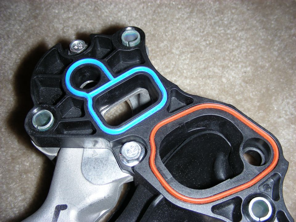Close-up of intake manifold gaskets with blue and orange seals