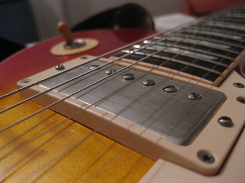 Close-up of electric guitar pickup and strings