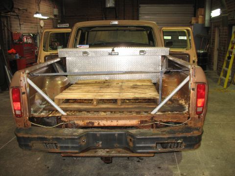 1978 Ford F-250 - Rear view of a 1978 Ford F-250 pickup truck, showing the bed with a toolbox and pallet.