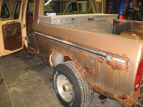 1978 Ford F-250 - This pickup truck shows significant rust damage along the lower body panels and wheel wells.