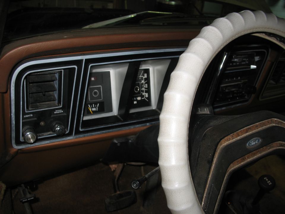Interior shot of a 1978 Ford F-250 dashboard, showing the instrument cluster, vents, and steering wheel