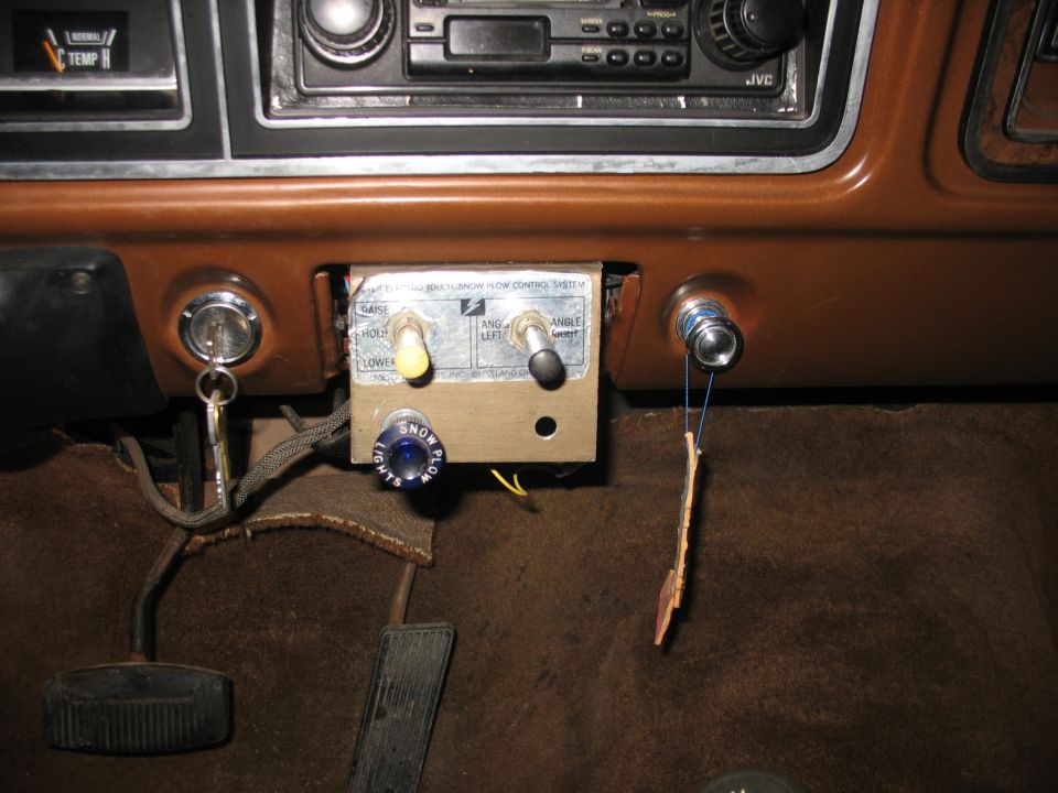 1978 Ford F-250 interior showing aftermarket snow plow controls with toggle switches and a blue button labeled SNOW PLOW LIGHTS