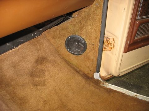 1978 Ford F-250 - Close-up of the interior passenger side footwell, highlighting the carpet and door jamb area.
