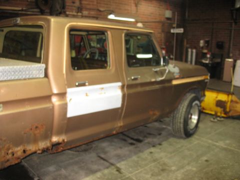 1978 Ford F-250 - Side view of a brown 1978 Ford F-250 pickup truck with significant rust damage on the lower body.