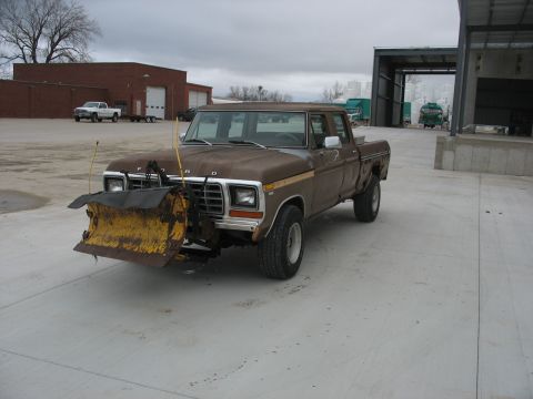 1978 Ford F-250 - This 1978 Ford F-250 pickup truck is equipped with a front-mounted snow plow and parked outdoors.