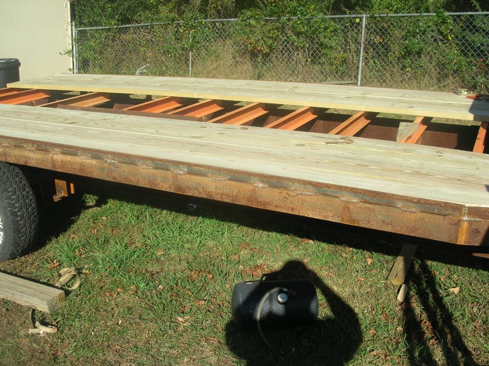 Gooseneck trailer with wooden deck and metal frame