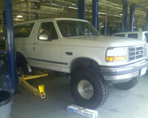 1992 Ford Bronco - 1992 Ford Bronco undergoing service on a vehicle lift.