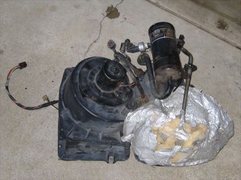 1996 Ford Bronco - Automotive HVAC blower motor and condenser unit shown on a concrete surface.
