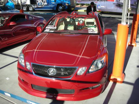 1998 Ford Crown Victoria - Front view of a red Lexus GS sedan, parked at an outdoor event with other vehicles and traffic cones.