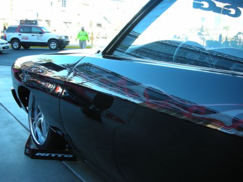 1998 Ford Crown Victoria - Customized car with flame graphics, seen at an event with other vehicles.