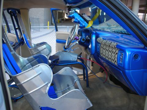 1998 Ford Crown Victoria - Interior view of a heavily modified truck with racing seats and a roll cage.