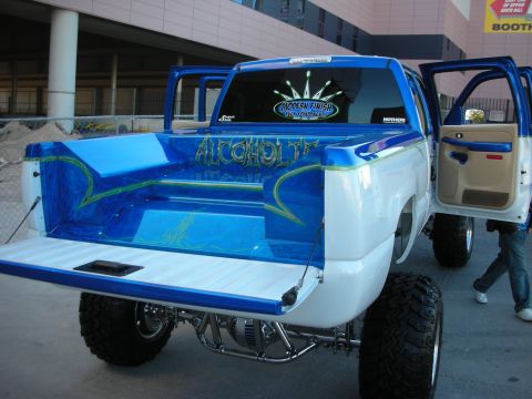 1998 Ford Crown Victoria - Custom pickup truck bed with elaborate paintwork and lettering, viewed from the rear.