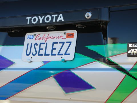 1998 Ford Crown Victoria - Close-up of a Toyota emblem and license plate on a vehicle with custom graphics.
