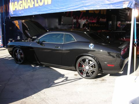 1998 Ford Crown Victoria - Black coupe with custom wheels and red brake calipers parked under a tent with a "Magnaflow" banner.