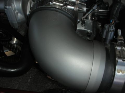 1998 Ford Crown Victoria - This image shows a close-up view of a vehicle's engine intake pipe and associated hardware.