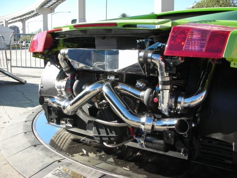 1998 Ford Crown Victoria - Close-up of a highly modified V8 engine with twin turbochargers and polished exhaust components.