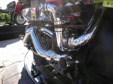 1998 Ford Crown Victoria - Custom engine bay features a polished turbocharger and exhaust system, with another vehicle visible in the background.