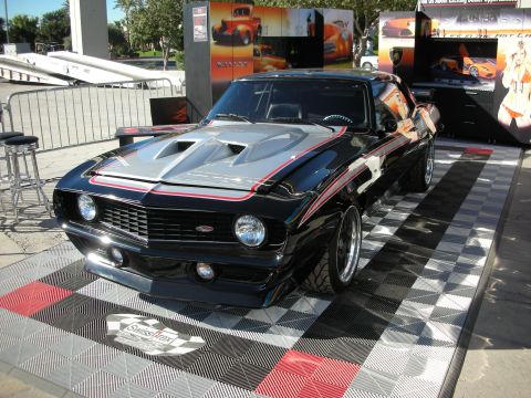 1998 Ford Crown Victoria - Custom 1969 Chevrolet Camaro displayed on a checkered floor at an event.