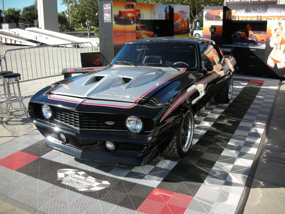 Black 1969 Chevrolet Camaro with silver hood scoops and red stripes