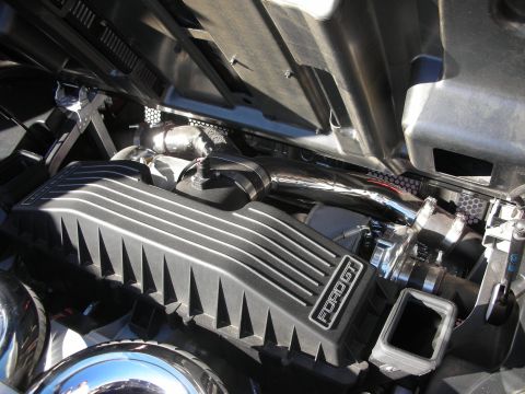 1998 Ford Crown Victoria - Close-up of a modified engine bay, showing a black engine cover with 'Ford GT' branding.