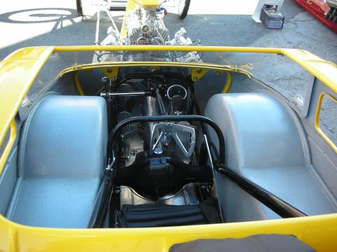 1998 Ford Crown Victoria - The exposed engine and minimalist interior of a custom drag racing vehicle are visible from above.