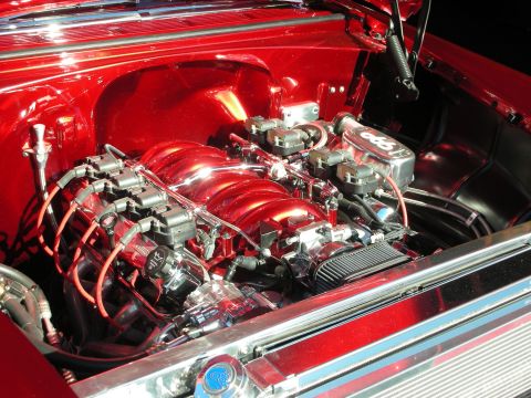 1998 Ford Crown Victoria - A highly polished engine bay features a modern V8 engine with chrome accents and red wiring.