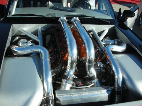 1998 Ford Crown Victoria - Customized engine bay with polished chrome piping and visible engine parts.