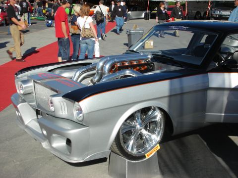 1998 Ford Crown Victoria - A highly modified classic car with its hood open showcases a powerful V8 engine and custom chrome wheels.