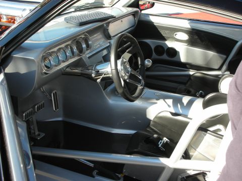 1998 Ford Crown Victoria - The interior of a modified car features a custom dashboard with multiple gauges and racing seats.