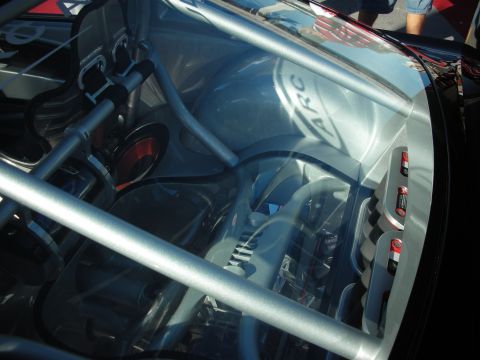 1998 Ford Crown Victoria - The interior of a race car is shown, a prominent roll cage, racing seats, and visible ARC branding on a panel.