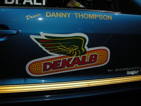 1998 Ford Crown Victoria - Side view of a blue car door the DEKALB logo and "Driver DANNY THOMPSON" text.