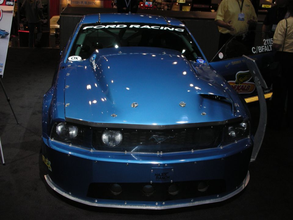 Blue Ford Mustang with "Ford Racing" banner, custom hood, and racing decals