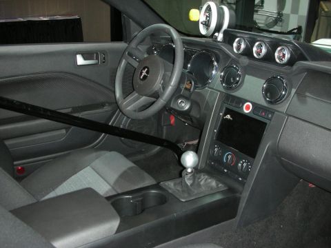 1998 Ford Crown Victoria - Interior view of a modified car a roll cage, auxiliary gauges, and a manual transmission shifter.