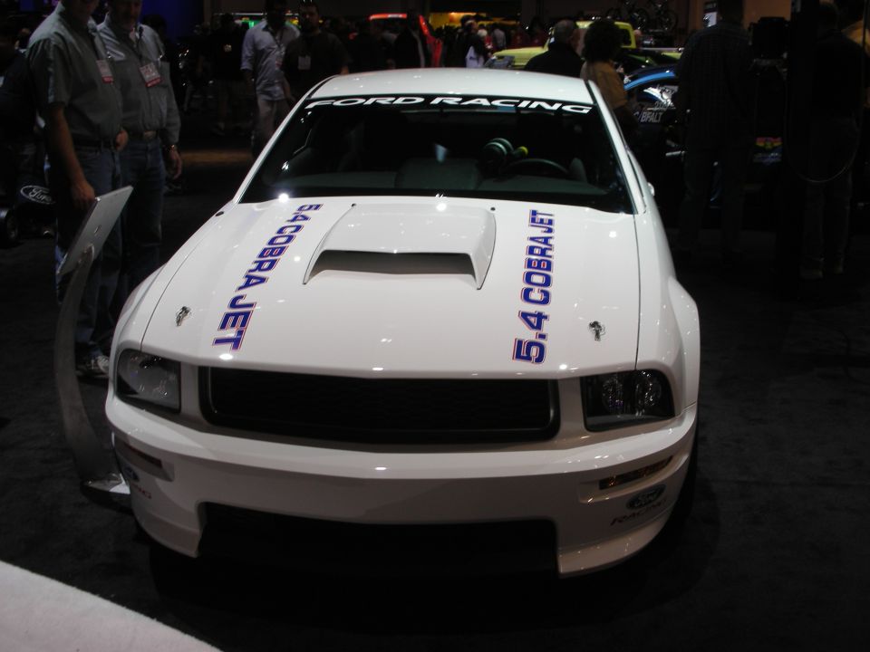 White Ford Mustang with '5.4 COBRA JET' and 'FORD RACING' decals, front view