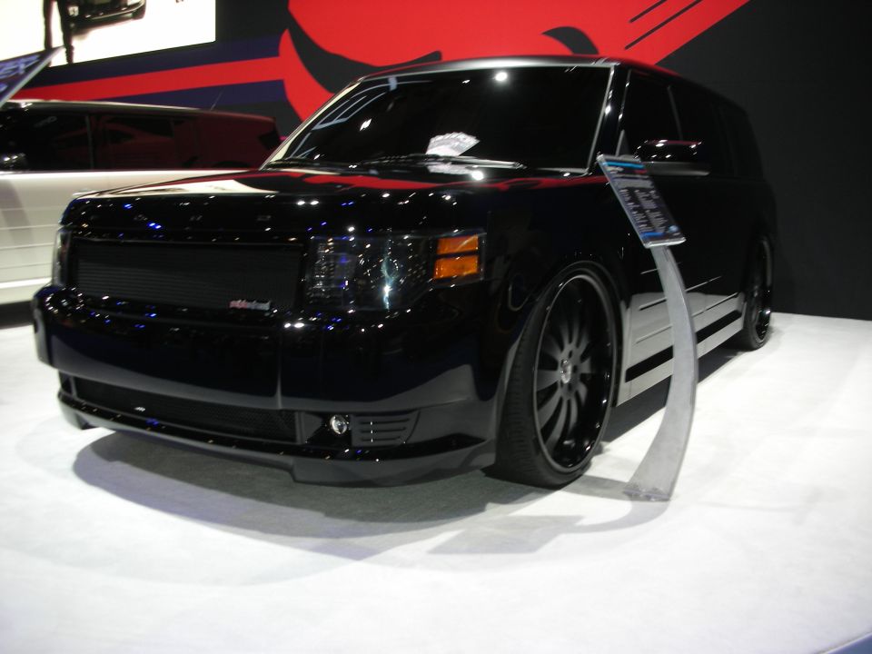 Black SUV with custom grille and tinted headlights on display