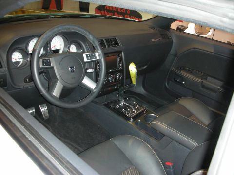 1998 Ford Crown Victoria - The interior of a Dodge Challenger features a custom yellow shifter and a Dodge logo on the steering wheel.