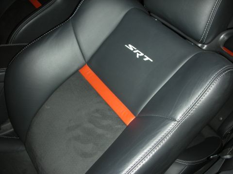 1998 Ford Crown Victoria - Close-up of a black car seat with an orange stripe and white SRT stitching.