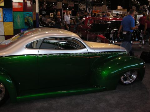 1998 Ford Crown Victoria - Custom hot rod coupe with two-tone paint and flame accents displayed at an indoor event.