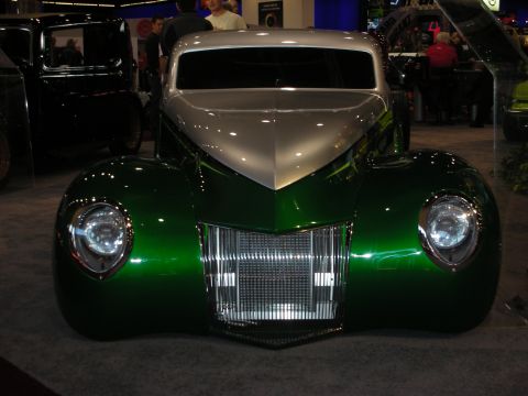 1998 Ford Crown Victoria - A custom hot rod with a two-tone paint job is displayed indoors.