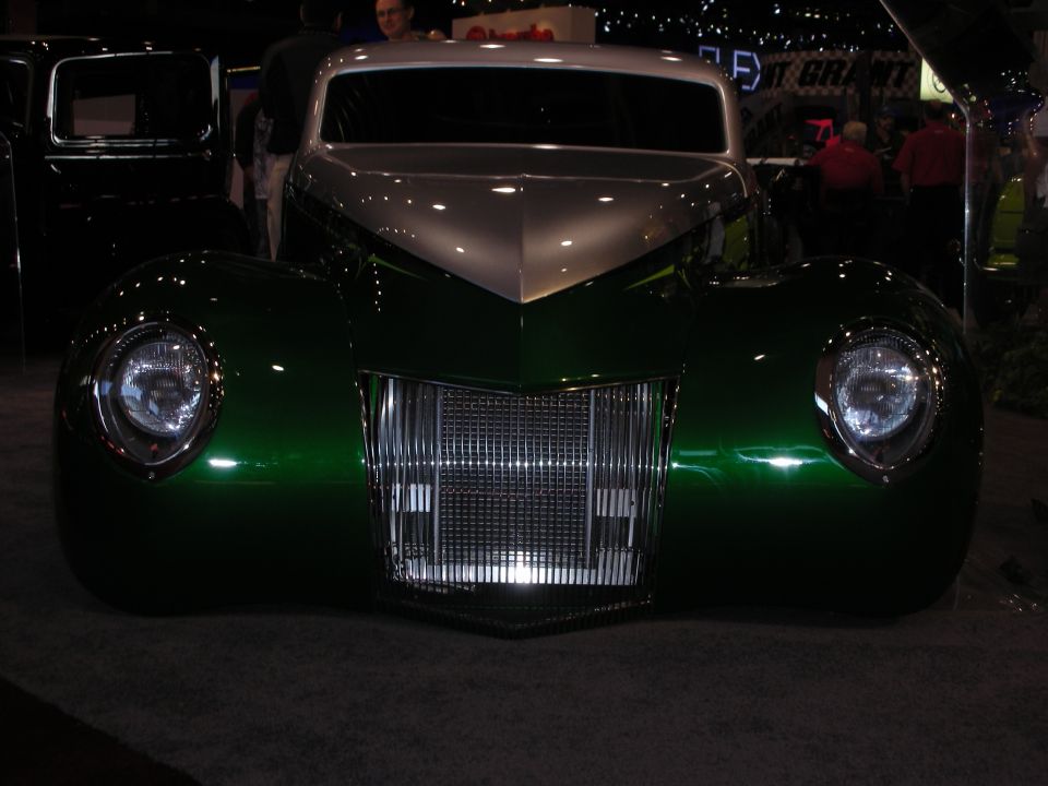 Green and silver customized hot rod front view, chrome grille, round headlights
