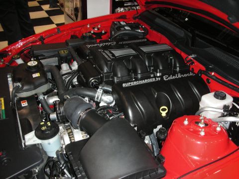 1998 Ford Crown Victoria - Close-up view of a supercharged engine bay, highlighting the Edelbrock components and red engine block.