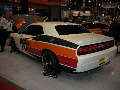 1998 Ford Crown Victoria - A white Dodge Challenger with K&N racing stripes is displayed with its hood open.