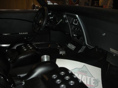 1998 Ford Crown Victoria - The interior of a custom car features racing-style seats and a modern dashboard with digital displays.